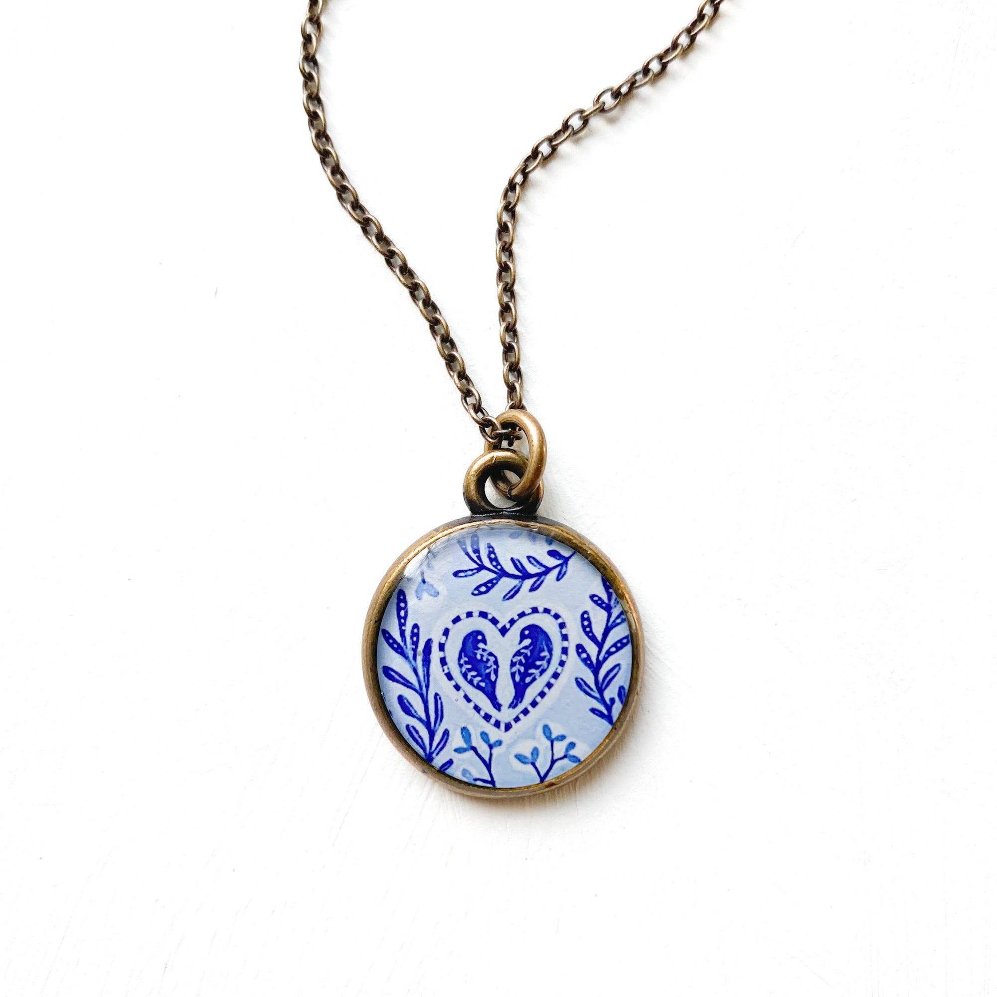 a necklace with a blue and white design on it