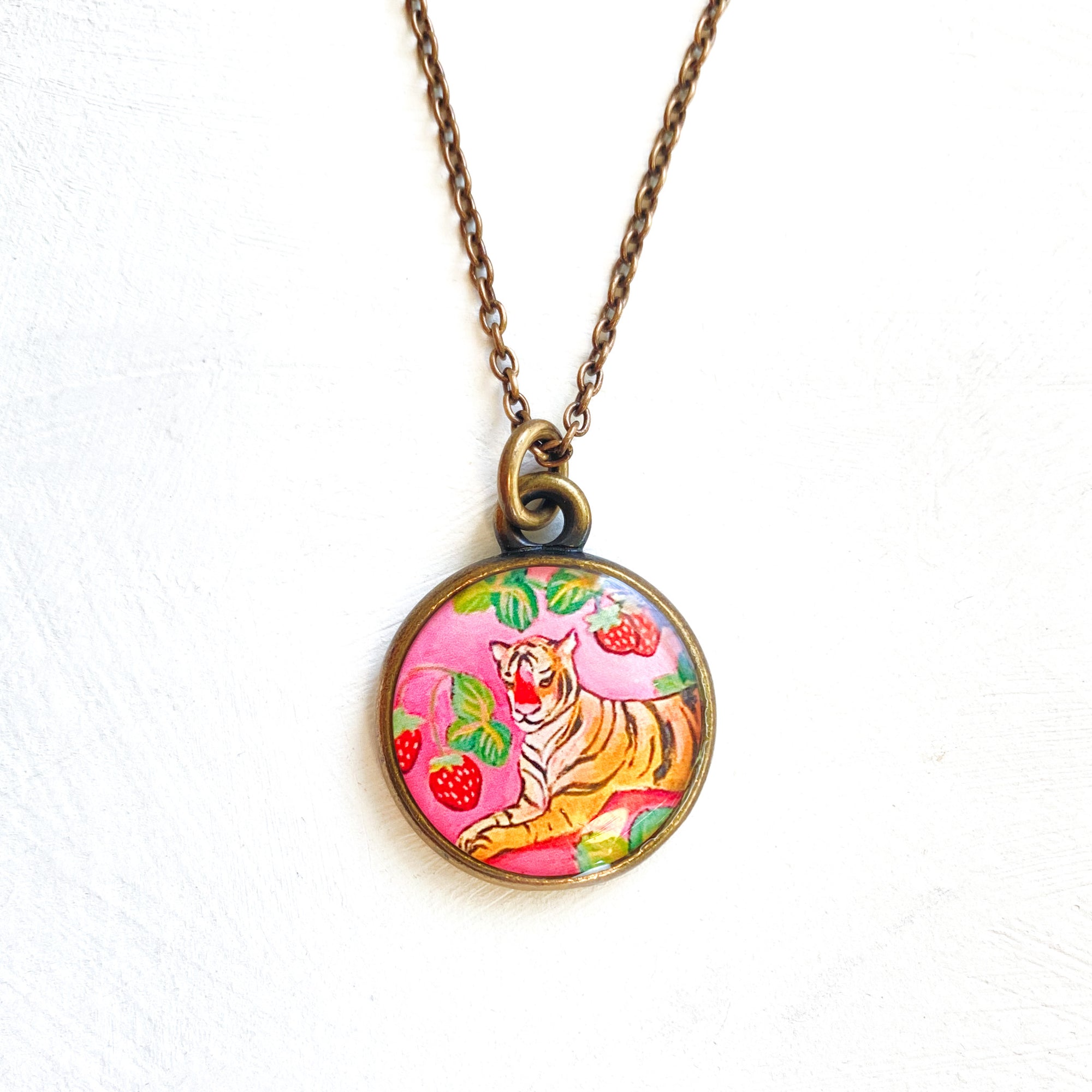 a necklace with a picture of a tiger on it