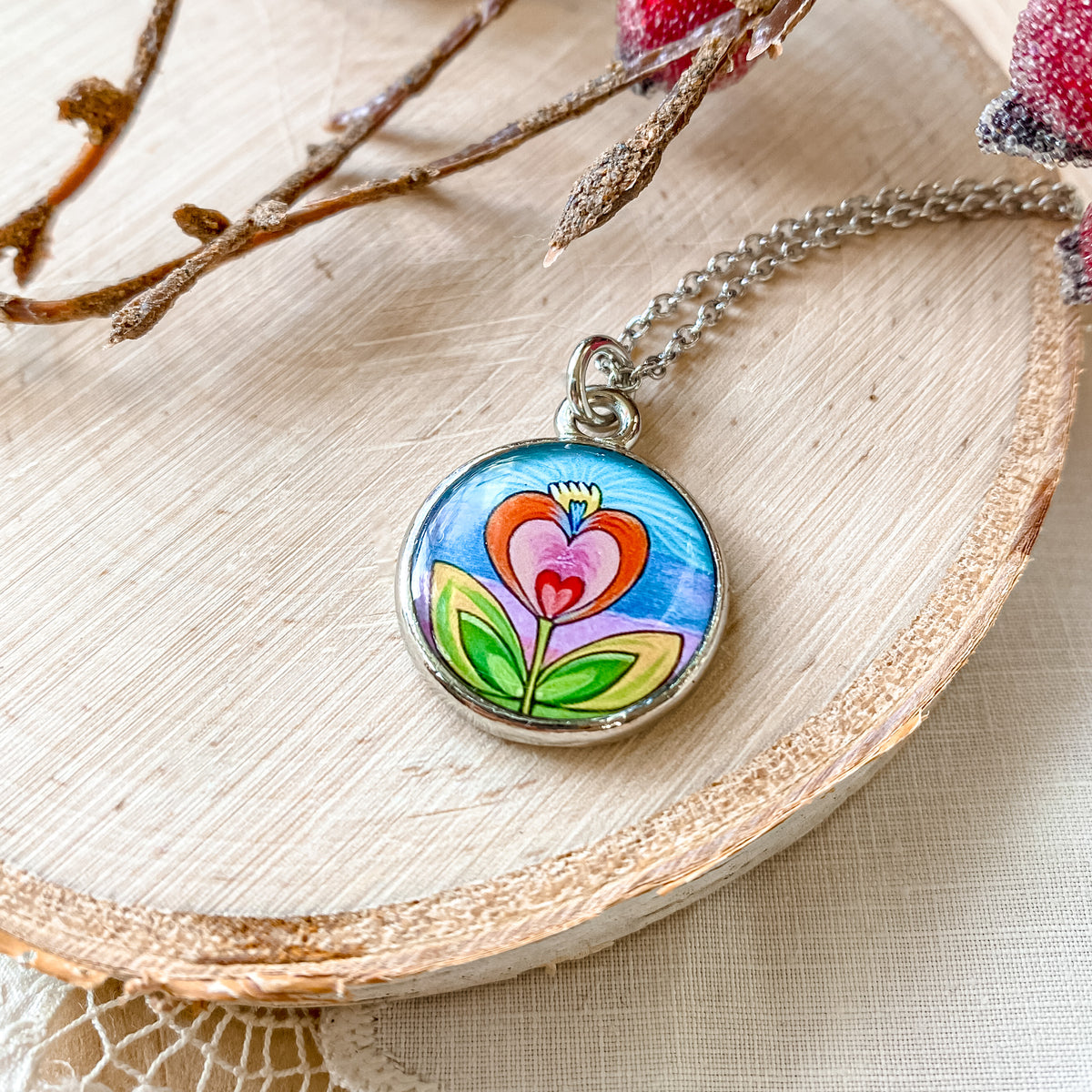 a necklace with a picture of a flower on it