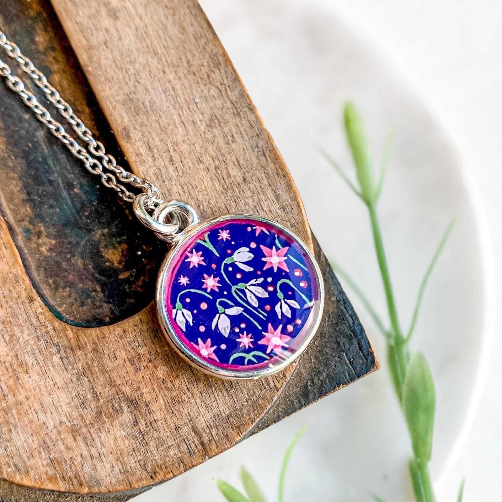 a necklace with a picture of an elephant on it