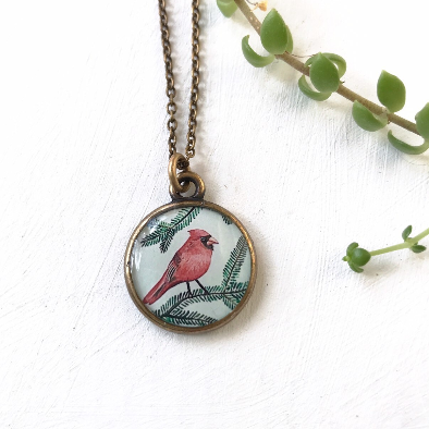 a necklace with a red bird on it