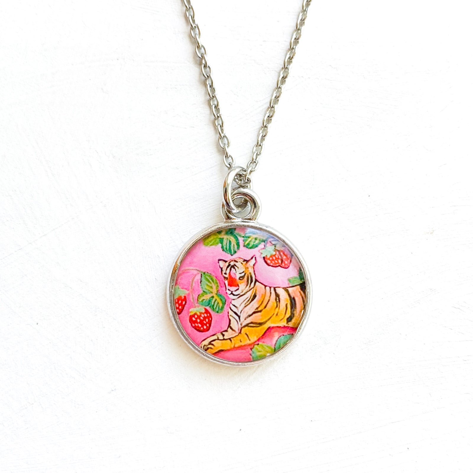 a necklace with a picture of a tiger on it