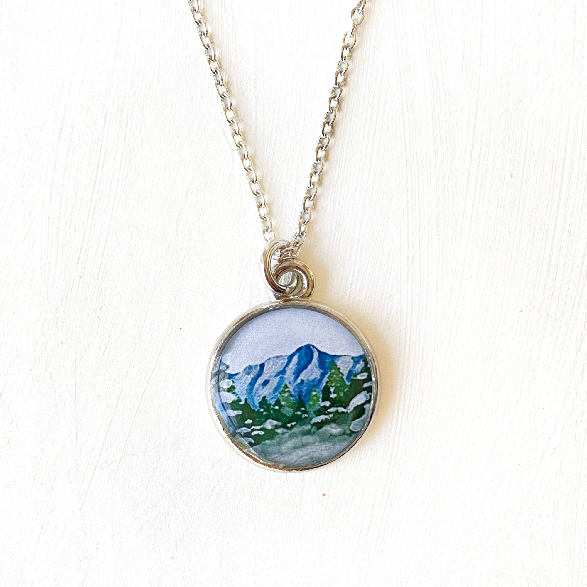 a necklace with a picture of a mountain on it