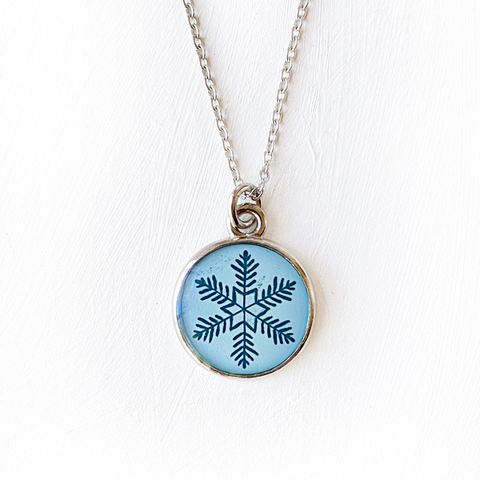 a necklace with a snowflake design on it