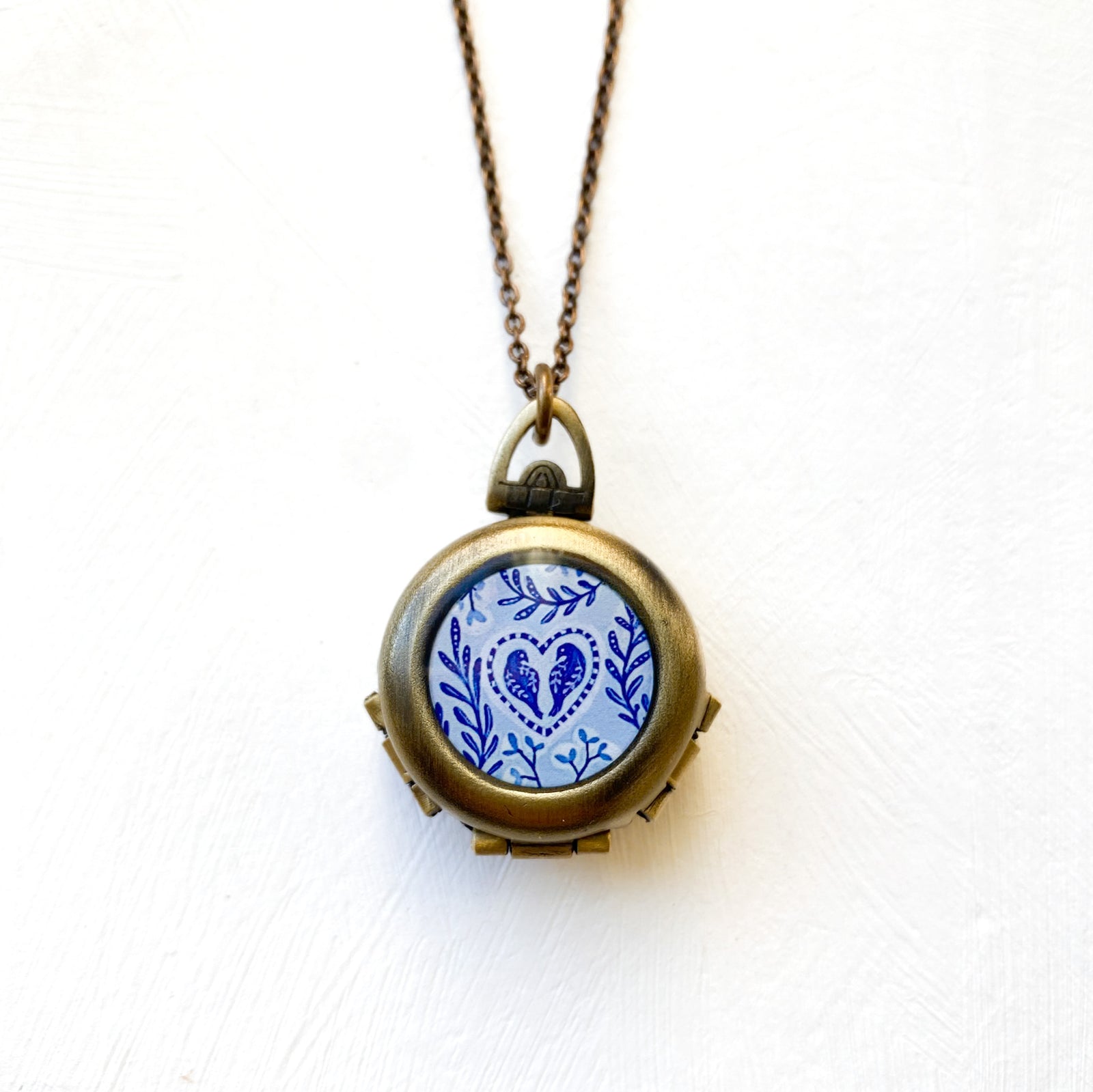 a necklace with a blue and white design on it