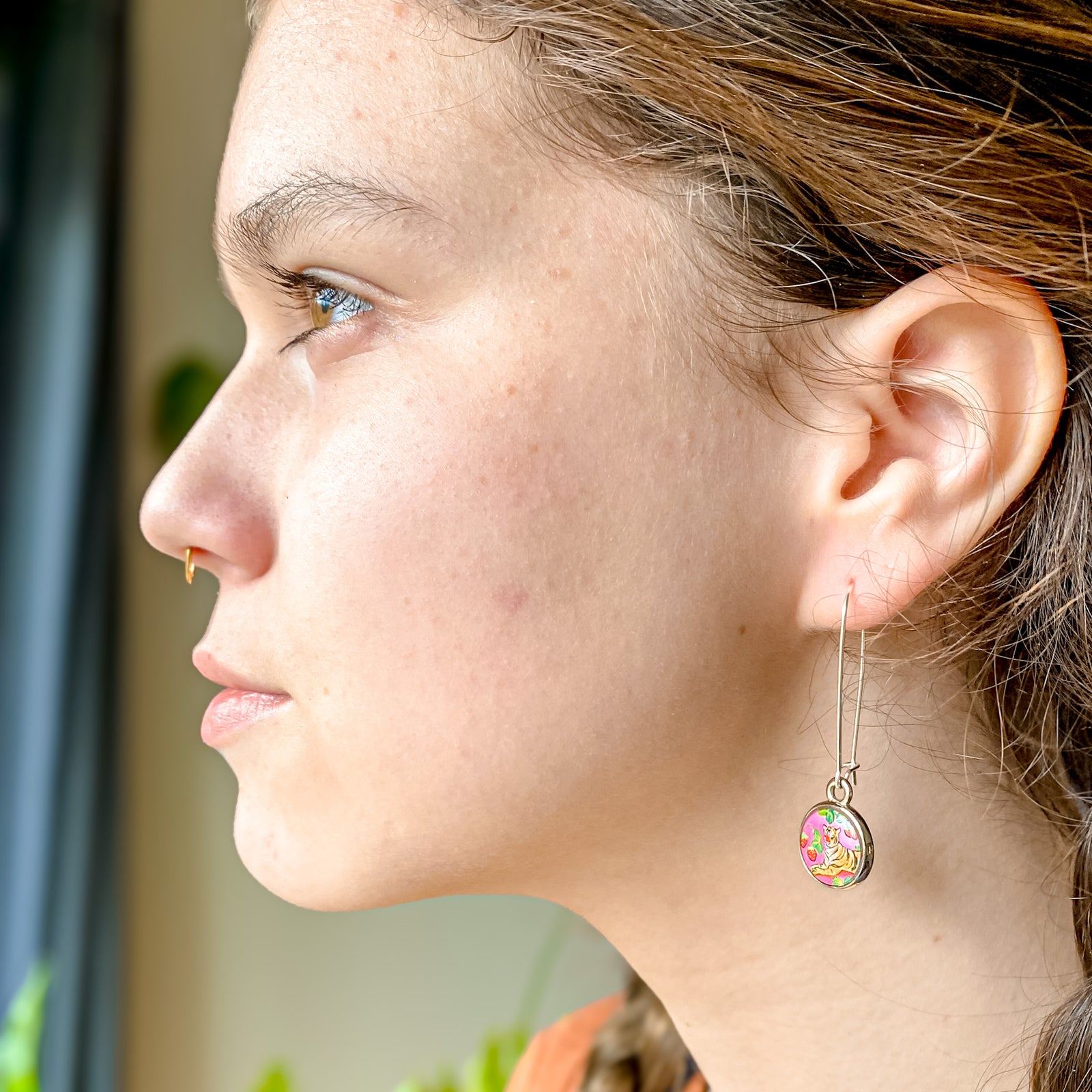 a young woman wearing a pair of earrings