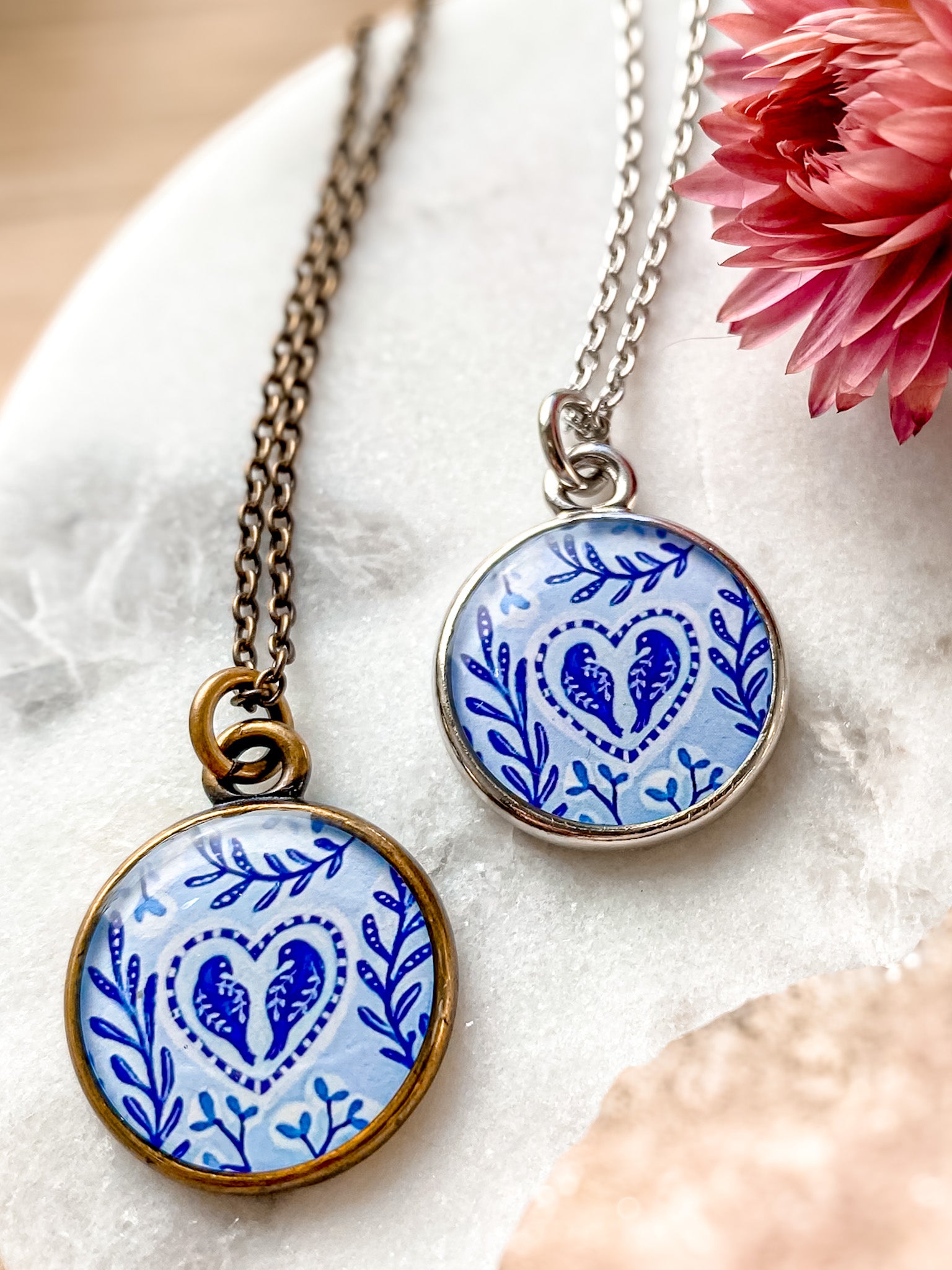 a necklace with a blue and white design on it