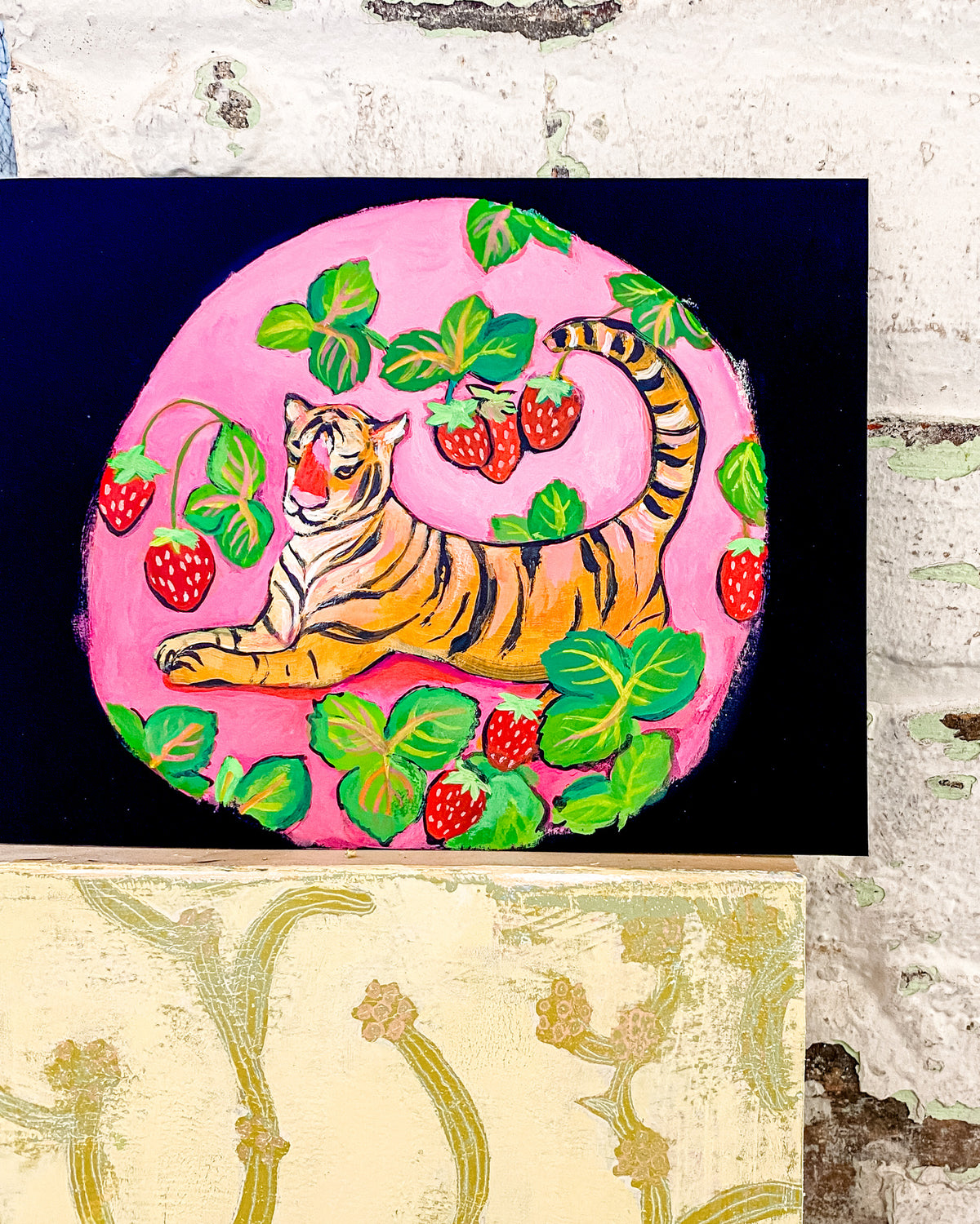 a painting of a tiger sitting on top of strawberries
