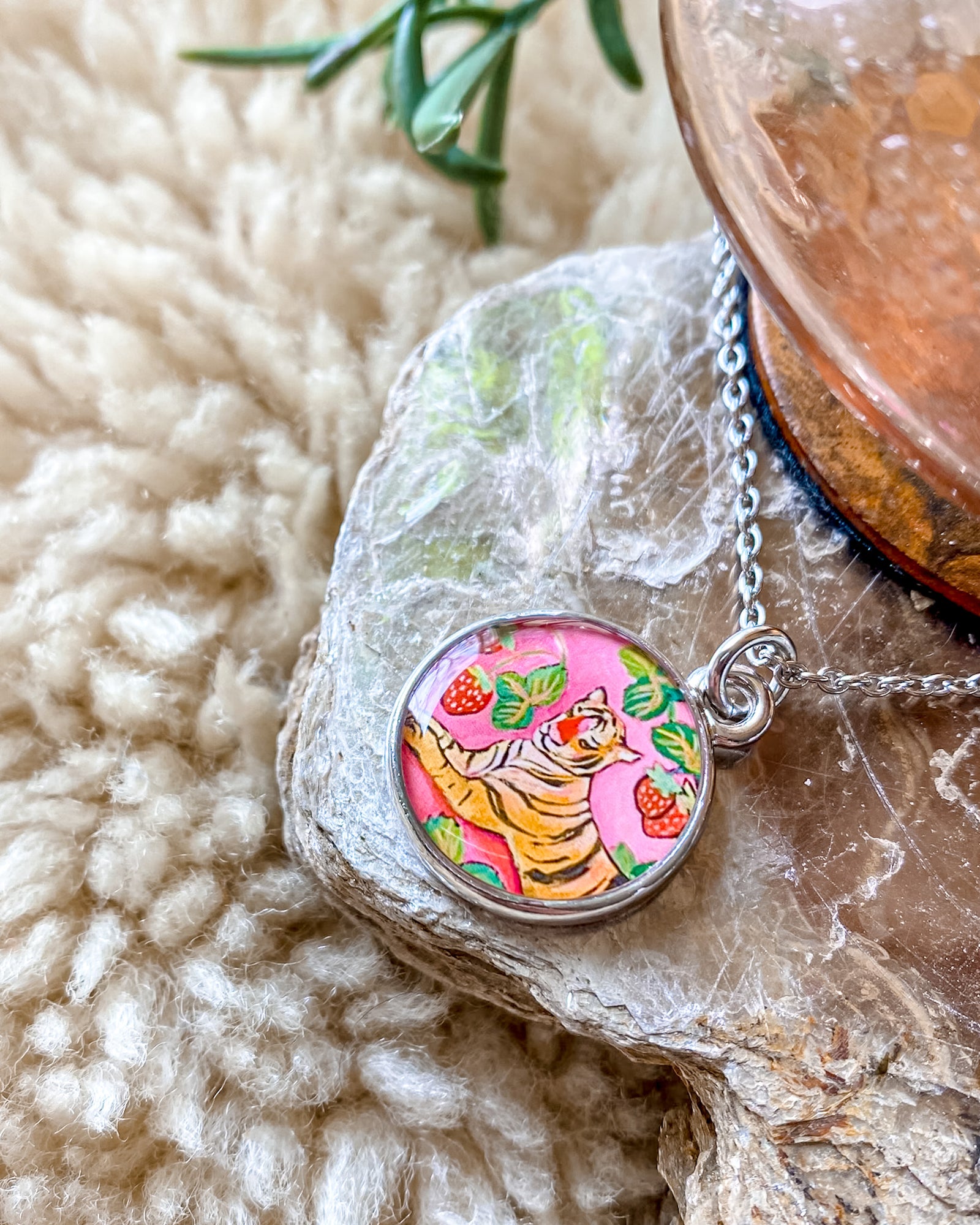 a necklace with a picture of a tiger on it