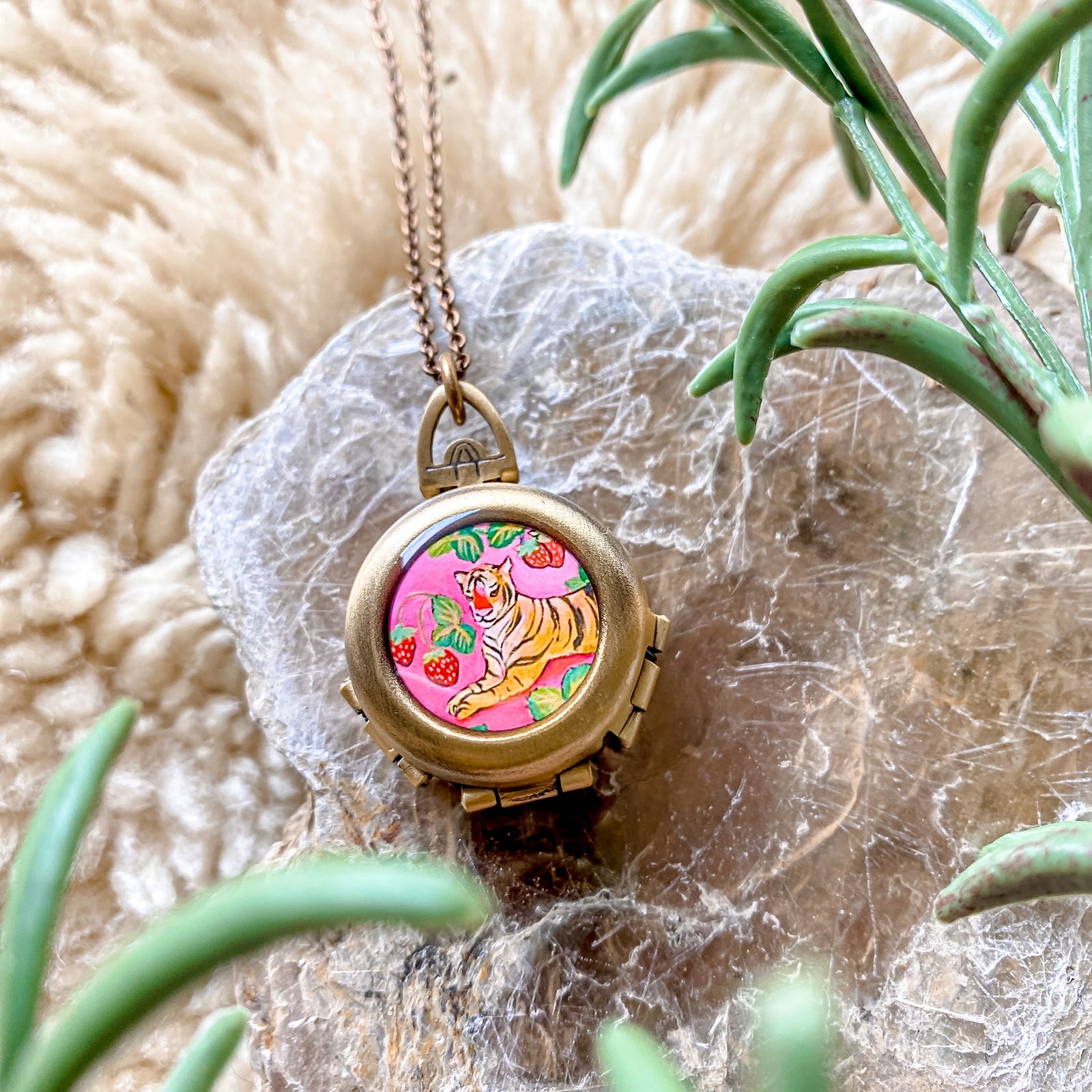 a necklace with a picture of a tiger on it