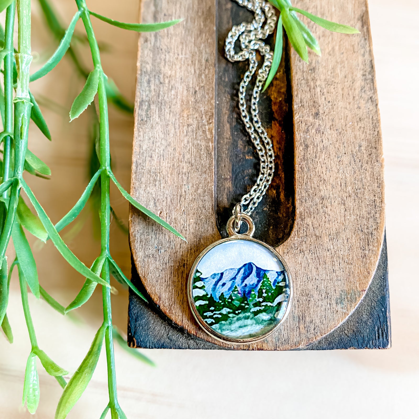 a necklace with a picture of a mountain on it